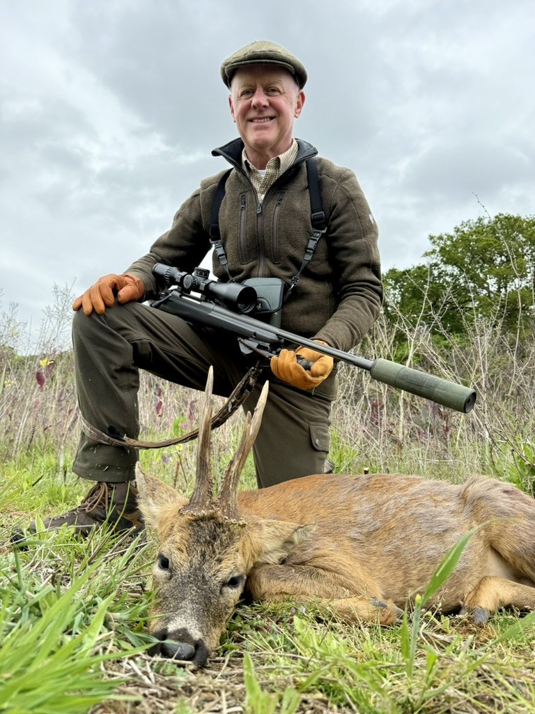 Todd with a Norfolk roe buck in spring wildflowers