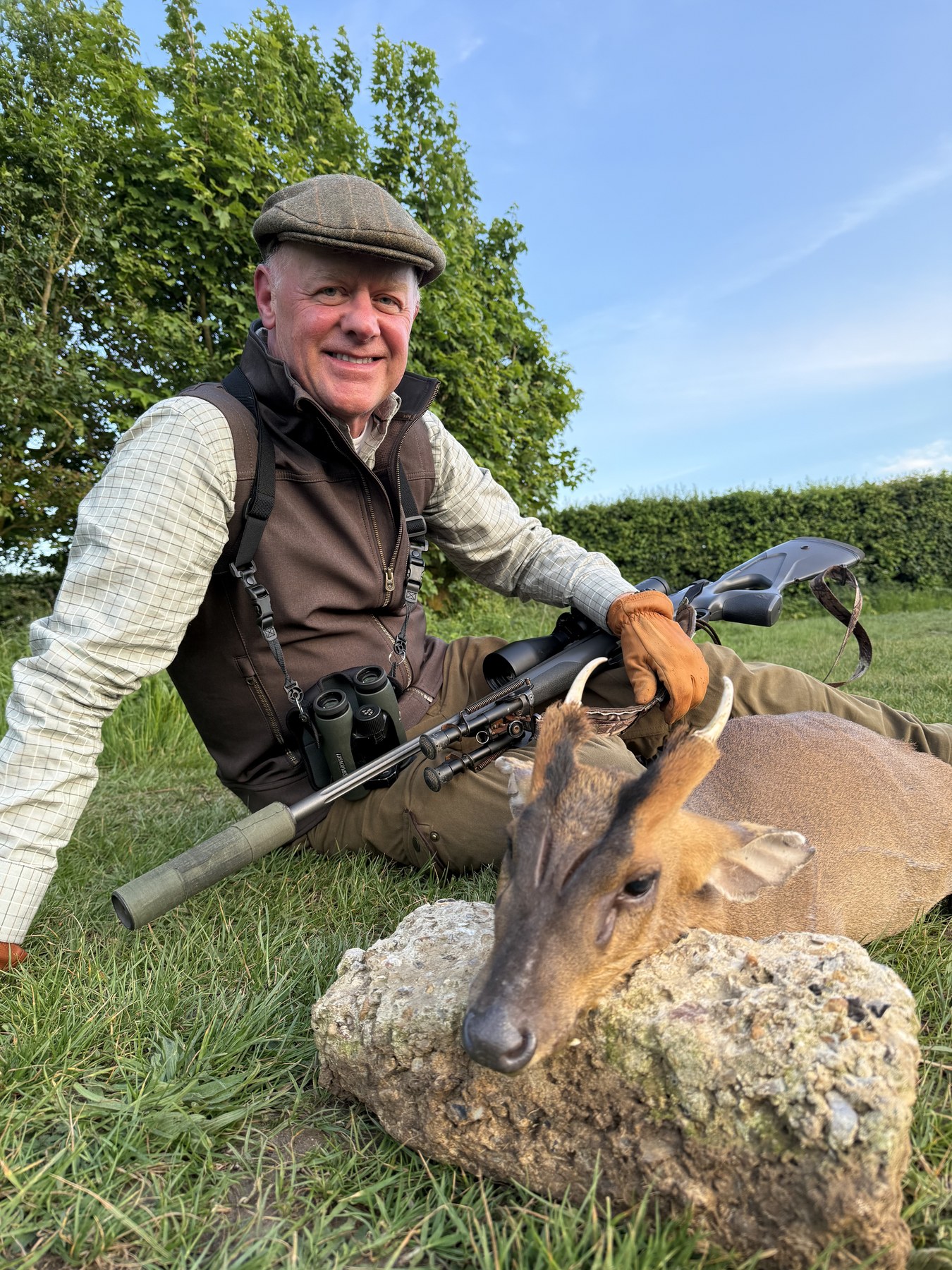 Client with a Norfolk muntjac buck on a flint stone