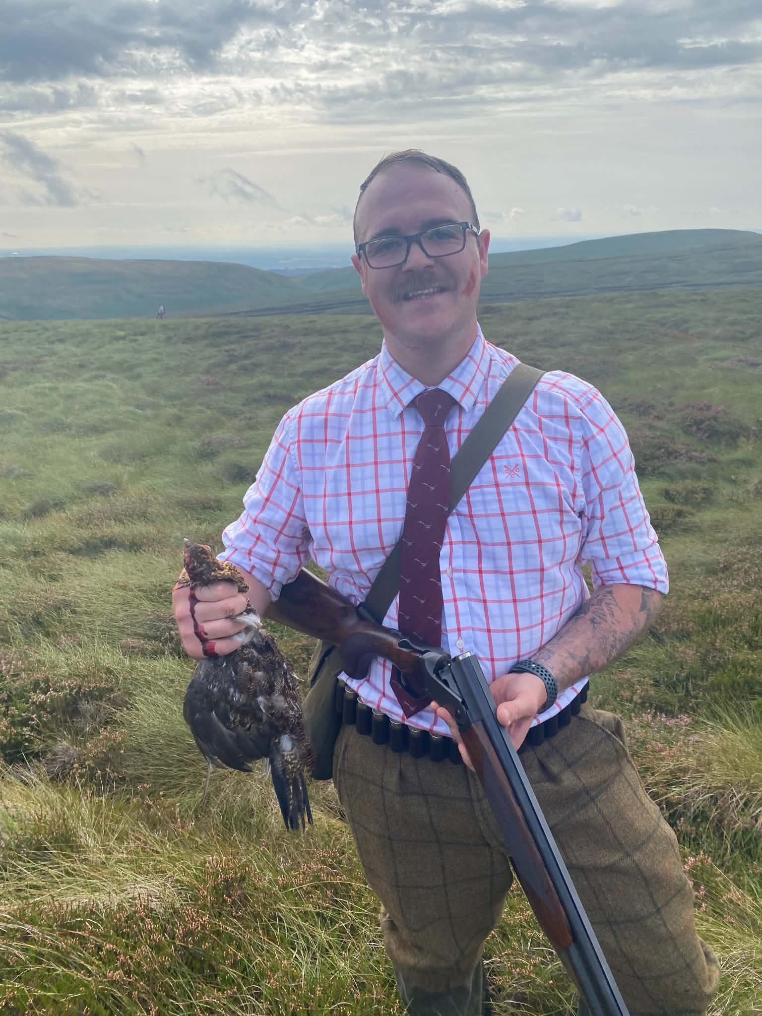Hunter with a brace of grouse